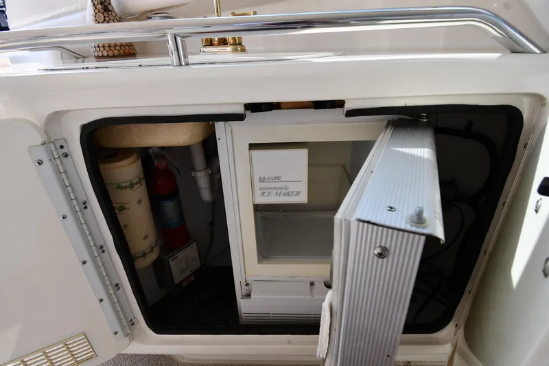  Yacht Photos Pics 1995 Sea Ray 630 Sundancer yacht interior with open storage compartment and ice maker.