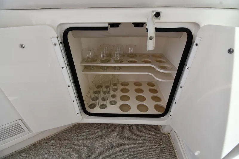  Yacht Photos Pics Glass storage cabinet on 1995 Sea Ray 630 Sundancer yacht, featuring organized compartments.