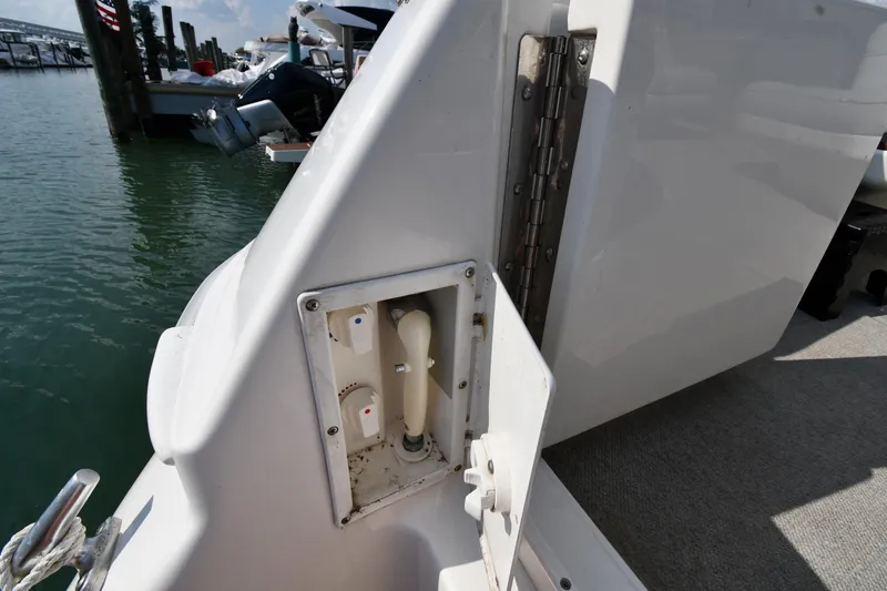  Yacht Photos Pics 1995 Sea Ray 630 Sundancer boat deck with utility panel, docked at marina.