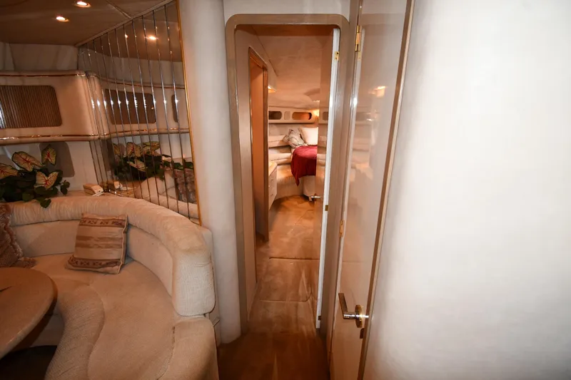  Yacht Photos Pics Luxurious interior of a 1995 Sea Ray 630 Sundancer yacht, featuring elegant seating and decor.
