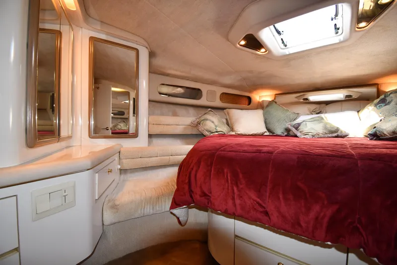  Yacht Photos Pics Luxurious cabin interior of 1995 Sea Ray 630 Sundancer with plush bedding and mirrors.