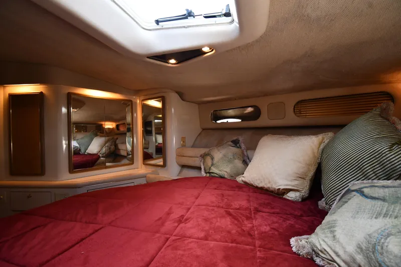  Yacht Photos Pics Luxurious 1995 Sea Ray 630 Sundancer cabin with plush bedding and elegant lighting.