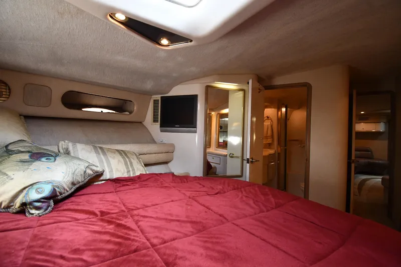  Yacht Photos Pics Luxurious cabin interior of 1995 Sea Ray 630 Sundancer yacht with red bedding.