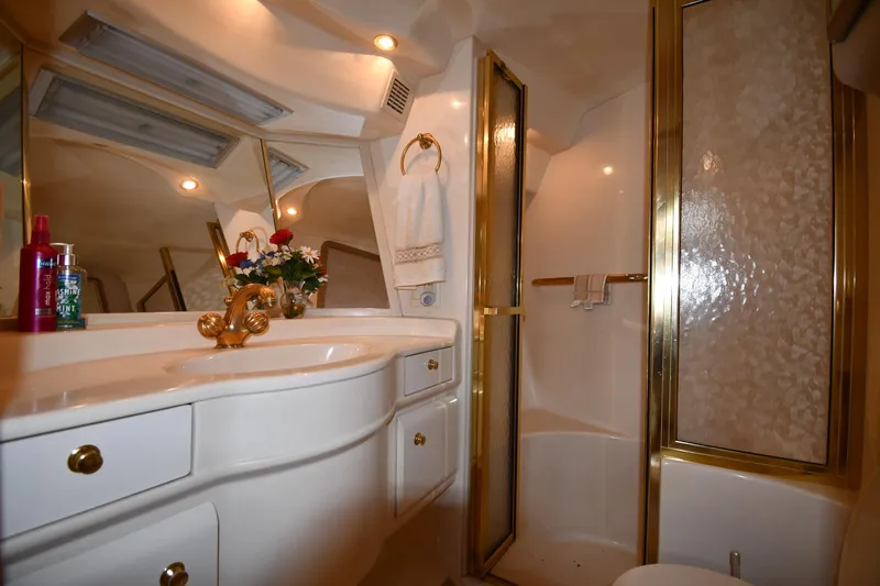  Yacht Photos Pics Luxurious bathroom interior of 1995 Sea Ray 630 Sundancer yacht with gold accents.