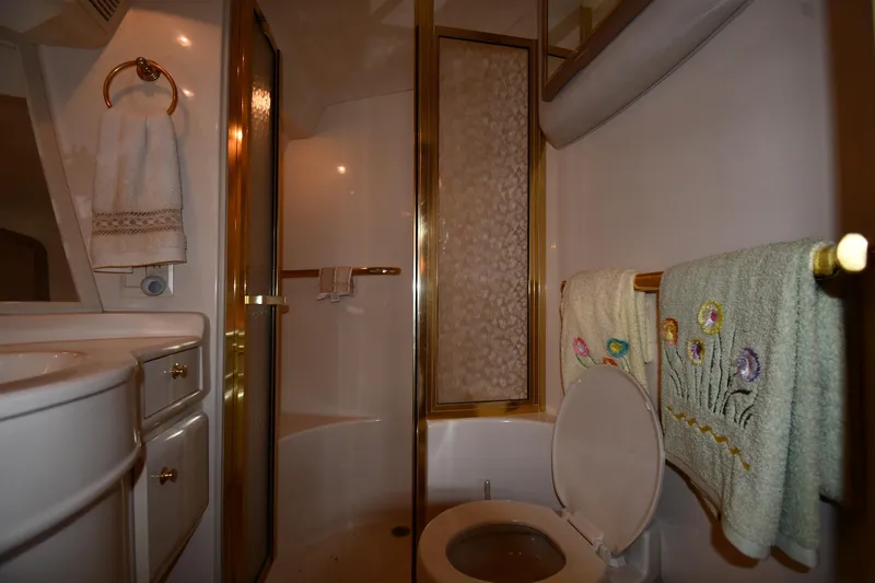  Yacht Photos Pics Bathroom interior of 1995 Sea Ray 630 Sundancer yacht with shower and decorative towels.