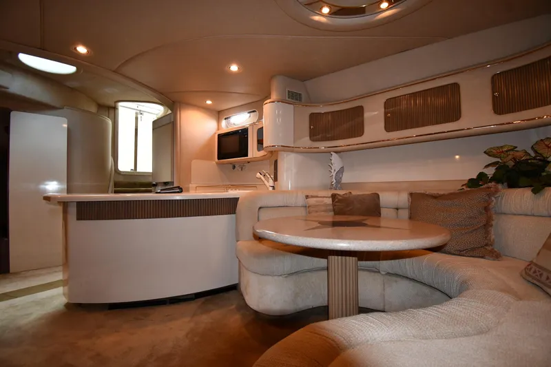  Yacht Photos Pics Luxurious interior of 1995 Sea Ray 630 Sundancer yacht with cozy seating and modern amenities.
