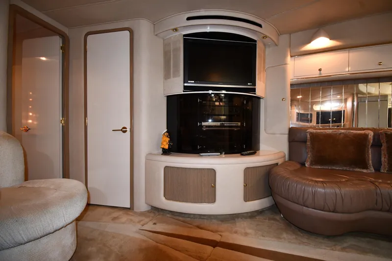  Yacht Photos Pics Luxurious interior of 1995 Sea Ray 630 Sundancer yacht with plush seating and entertainment center.