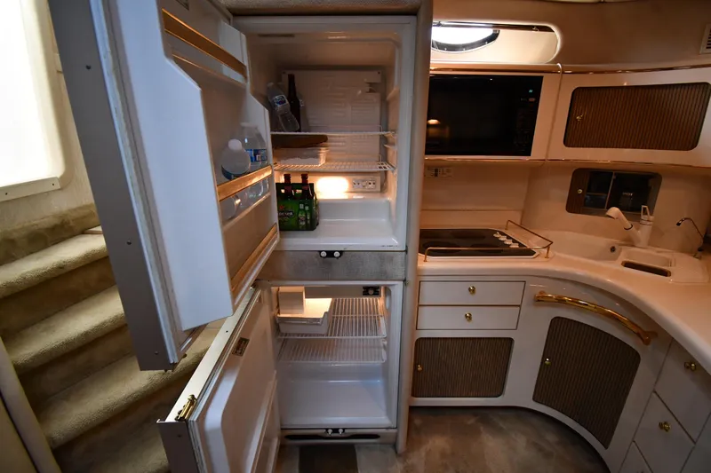  Yacht Photos Pics Interior of 1995 Sea Ray 630 Sundancer yacht kitchen with open fridge and modern amenities.