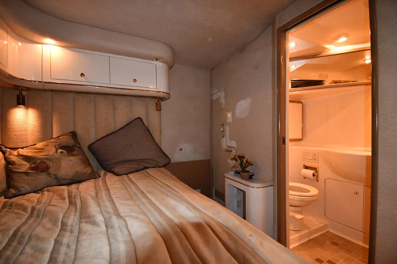  Yacht Photos Pics Cozy cabin interior of 1995 Sea Ray 630 Sundancer with bed and ensuite bathroom.