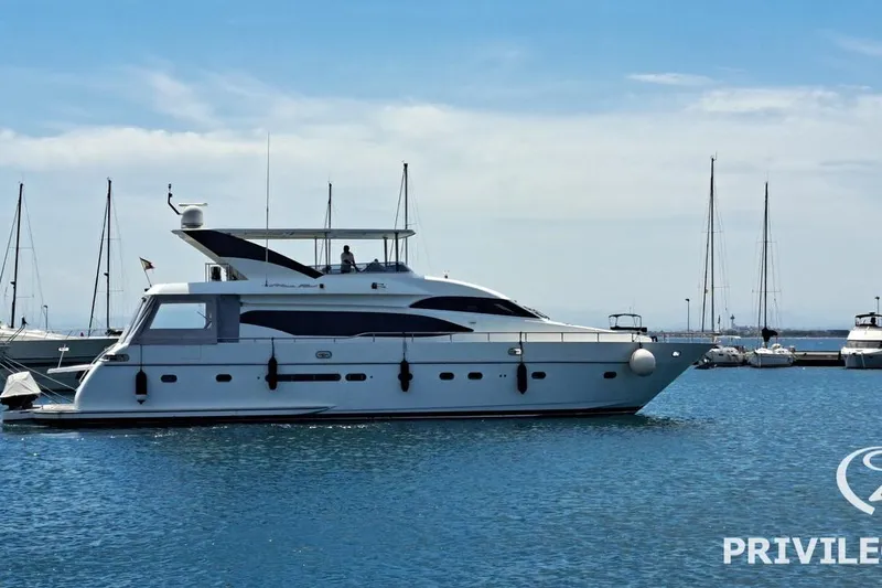  Yacht Photos Pics Luxury Monte Fino 76 yacht from 2006 docked in a serene marina setting.