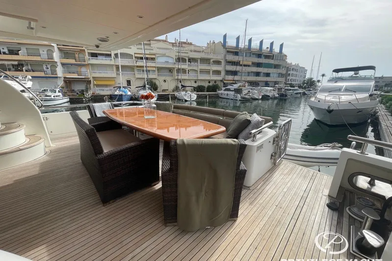  Yacht Photos Pics Luxury Monte Fino 76 yacht deck with dining area, docked in a marina, 2006 model.