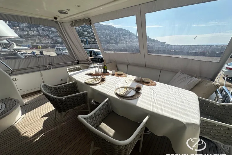  Yacht Photos Pics Luxurious dining area on a 2006 Monte Fino 76 yacht, featuring elegant table settings.