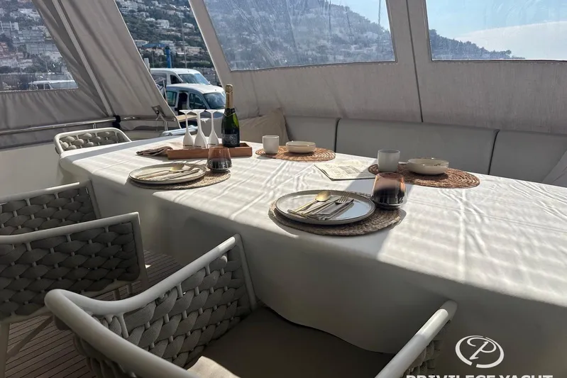  Yacht Photos Pics Elegant dining setup on 2006 Monte Fino 76 yacht with scenic views.