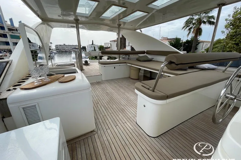  Yacht Photos Pics Luxurious 2006 Monte Fino 76 yacht deck with seating, glassware, and scenic marina view.