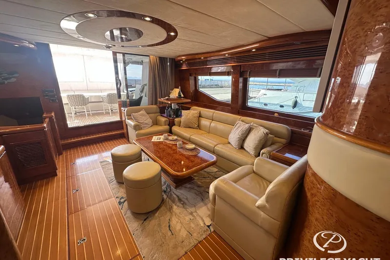  Yacht Photos Pics Luxurious interior of 2006 Monte Fino 76 yacht with elegant seating and wooden finishes.