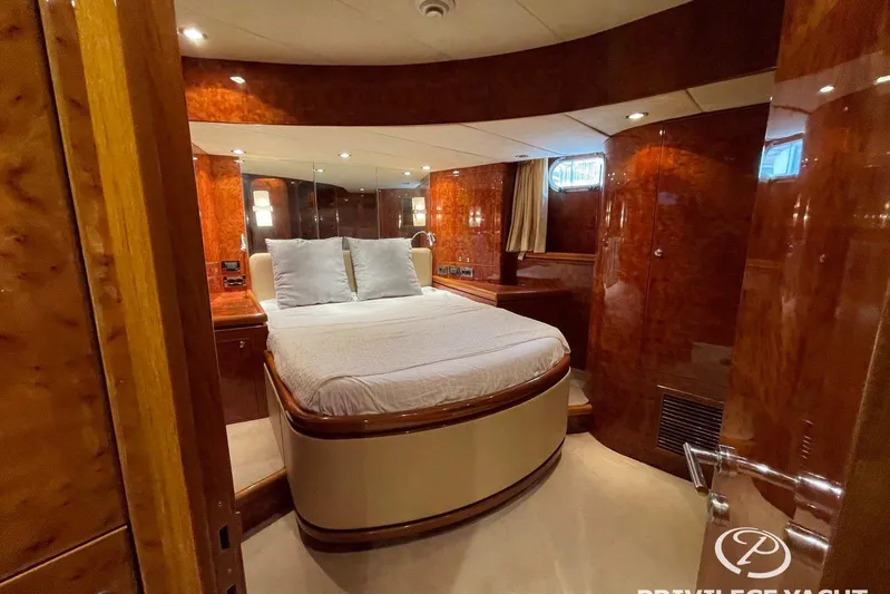  Yacht Photos Pics Luxurious bedroom interior of 2006 Monte Fino 76 yacht with elegant wood finishes.
