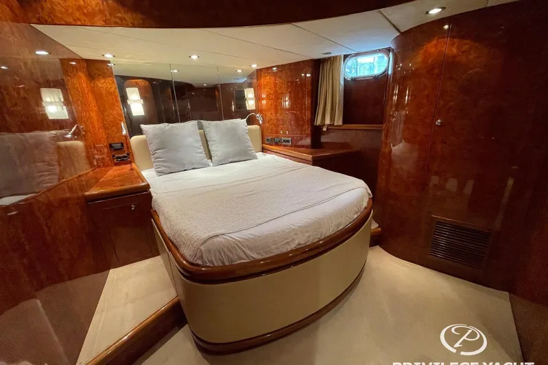  Yacht Photos Pics Luxurious bedroom interior of 2006 Monte Fino 76 yacht with wood paneling and cozy bed.