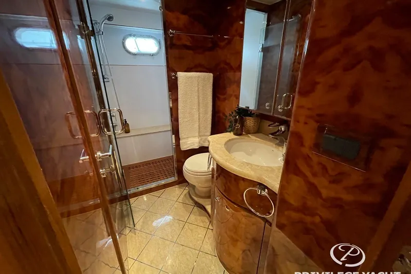  Yacht Photos Pics Luxurious bathroom on a 2006 Monte Fino 76 yacht with elegant wood finishes.
