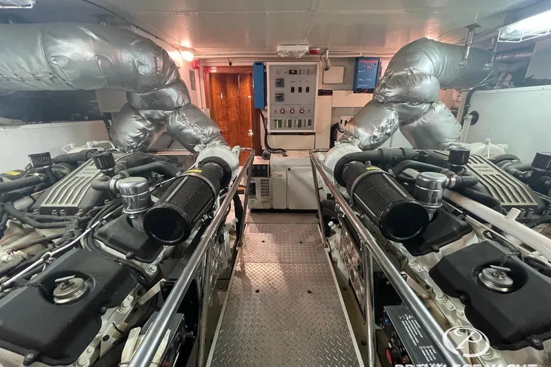  Yacht Photos Pics Engine room of a 2006 Monte Fino 76 yacht, featuring dual engines and control panels.