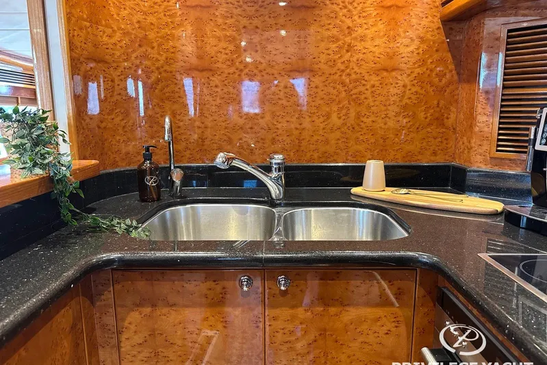  Yacht Photos Pics Luxurious kitchen sink area on a 2006 Monte Fino 76 yacht with elegant wood finish.