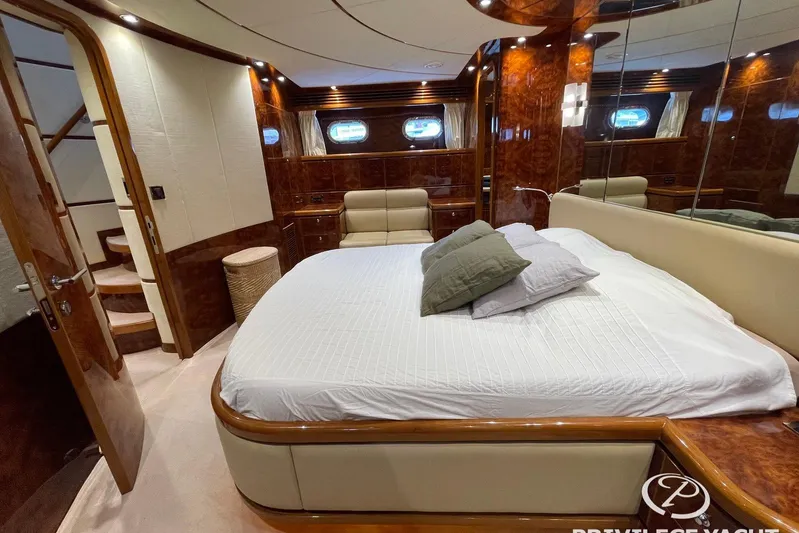  Yacht Photos Pics Luxurious bedroom interior of 2006 Monte Fino 76 yacht with elegant wood finishes.