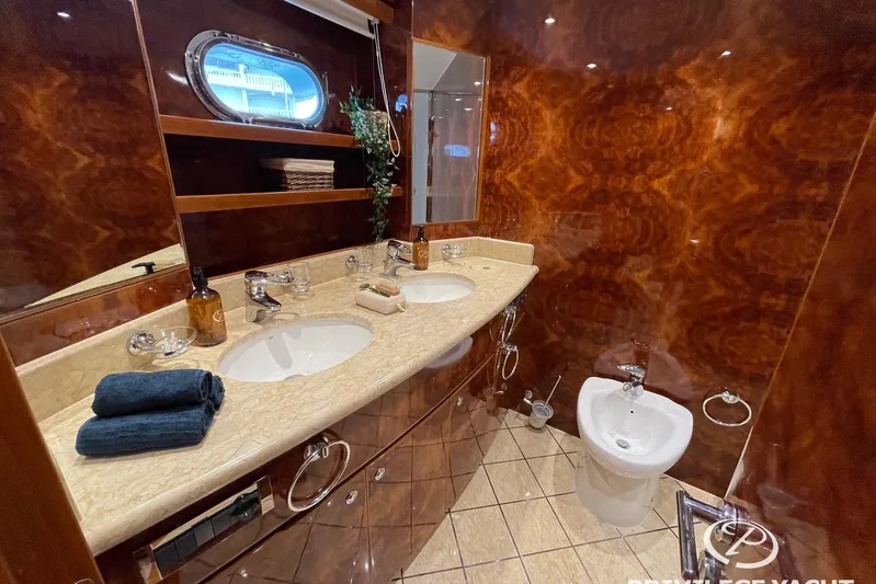  Yacht Photos Pics Luxurious bathroom in 2006 Monte Fino 76 yacht with dual sinks and elegant wood finish.