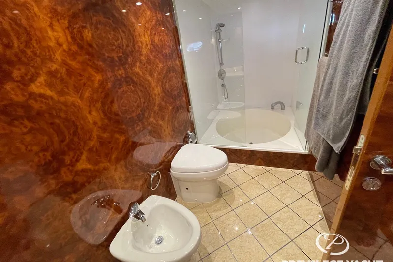  Yacht Photos Pics Luxurious bathroom on 2006 Monte Fino 76 yacht with wood paneling and modern fixtures.