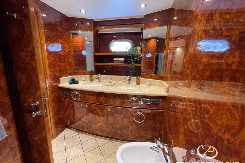  Yacht Photos Pics Luxurious bathroom in 2006 Monte Fino 76 yacht with wood paneling and dual sinks.