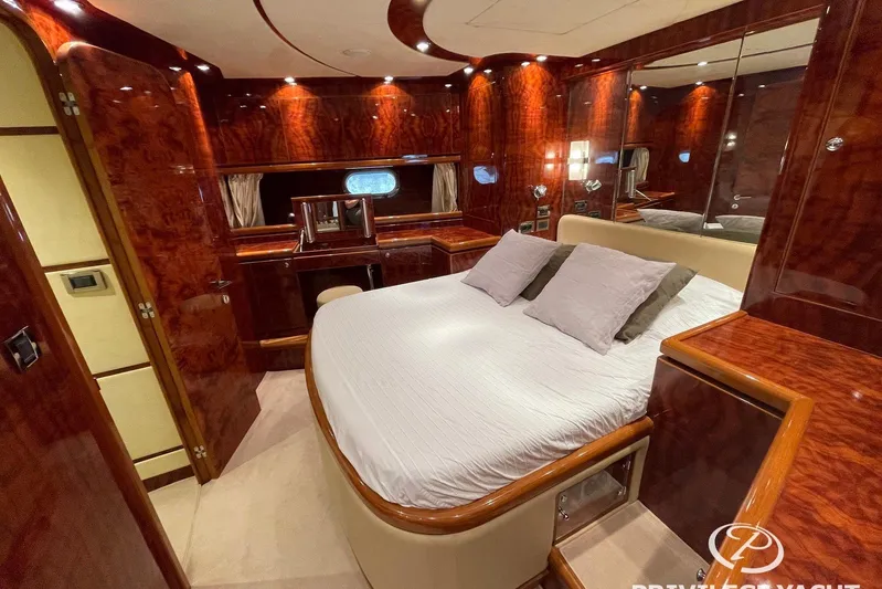  Yacht Photos Pics Luxurious 2006 Monte Fino 76 yacht bedroom with elegant wood finish and plush bedding.
