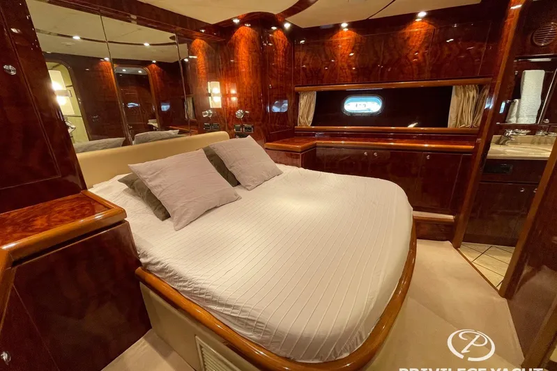  Yacht Photos Pics Luxurious bedroom interior of 2006 Monte Fino 76 yacht with elegant wood finishes.