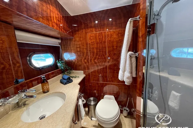  Yacht Photos Pics Luxurious bathroom in 2006 Monte Fino 76 yacht with elegant wood paneling and modern fixtures.