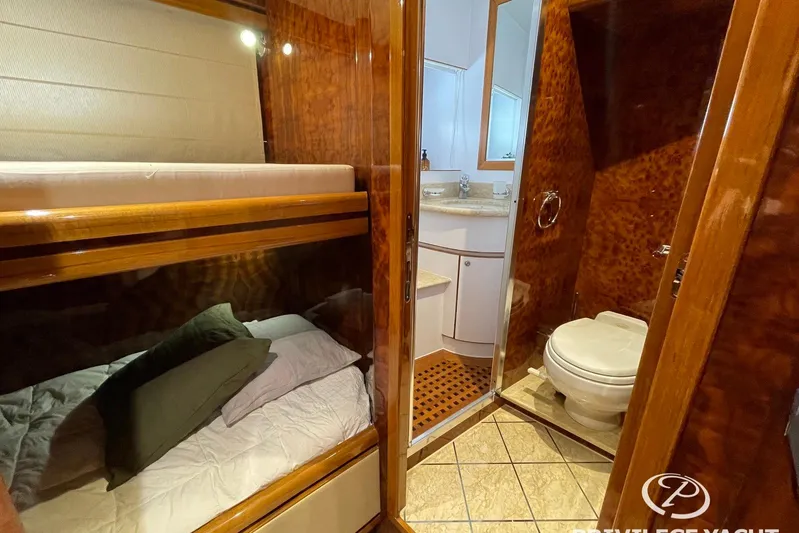  Yacht Photos Pics Luxurious Monte Fino 76 yacht interior, featuring cozy bunk beds and elegant bathroom, 2006 model.