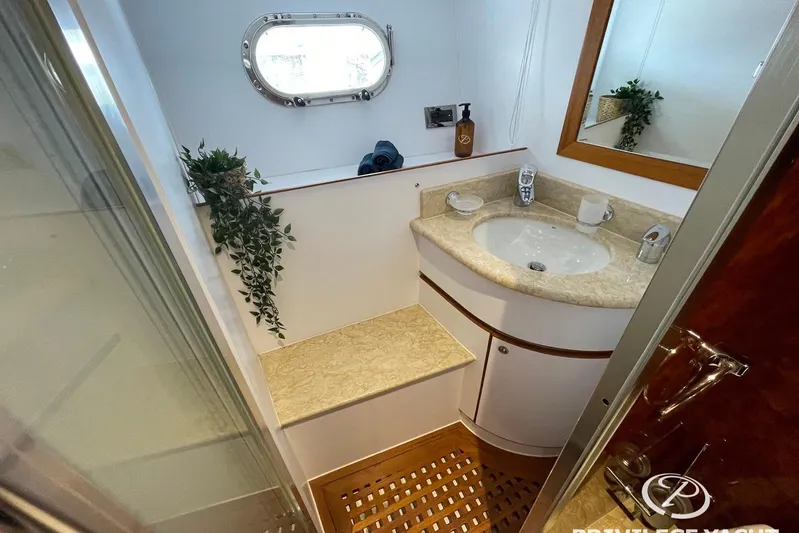  Yacht Photos Pics Luxurious bathroom in 2006 Monte Fino 76 yacht with elegant sink and porthole window.