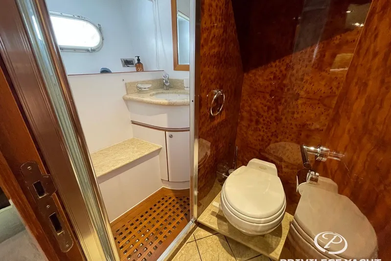  Yacht Photos Pics Luxurious bathroom on 2006 Monte Fino 76 yacht with elegant wood paneling and modern fixtures.