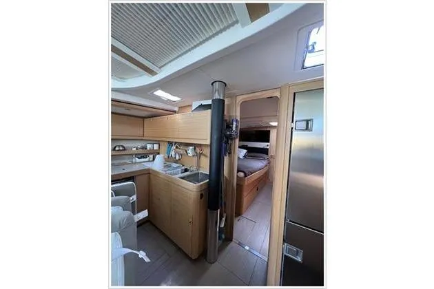  Yacht Photos Pics Interior of 2017 Dufour Exclusive 56 yacht, featuring modern kitchen and cozy sleeping area.