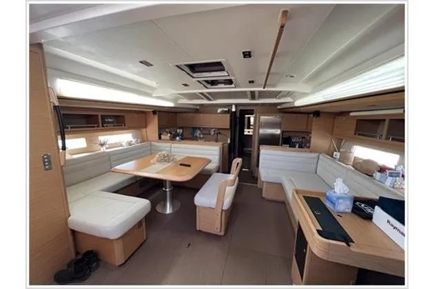  Yacht Photos Pics Luxurious interior of 2017 Dufour Exclusive 56 yacht with modern seating and dining area.