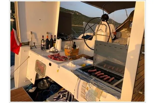  Yacht Photos Pics Outdoor kitchen on 2017 Dufour Exclusive 56 yacht with grill and wine bottles.