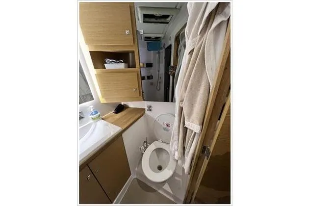  Yacht Photos Pics Bathroom interior of 2017 Dufour Exclusive 56 yacht, featuring modern fixtures and wooden cabinetry.