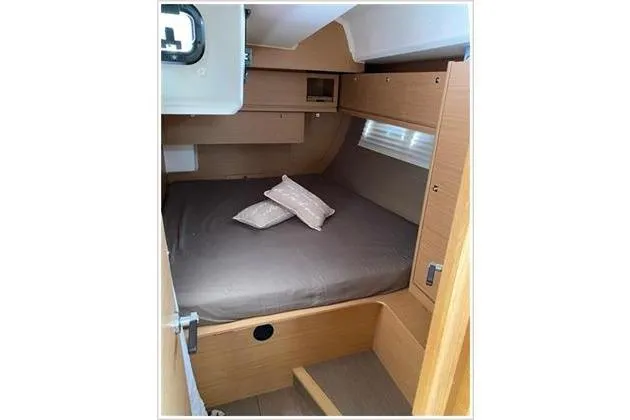  Yacht Photos Pics Cozy cabin interior of 2017 Dufour Exclusive 56 yacht with bed and pillows.