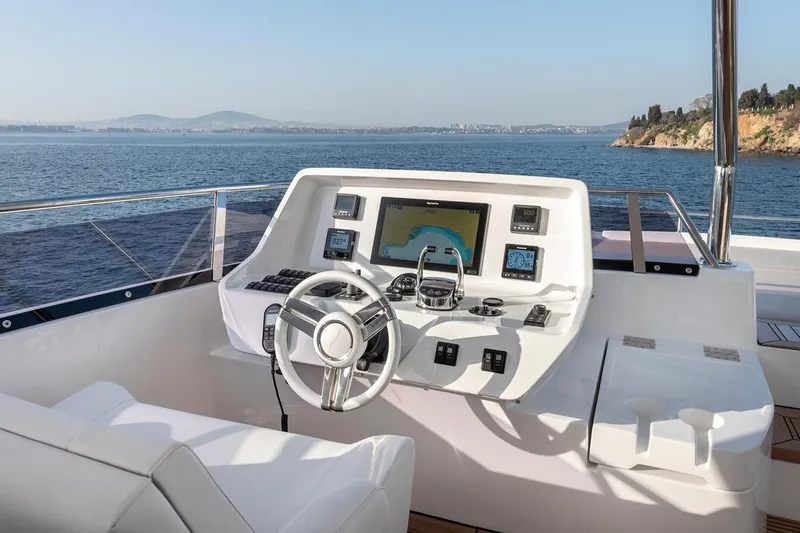  Yacht Photos Pics Helm of 2022 Numarine 22XP yacht with navigation controls and ocean view.