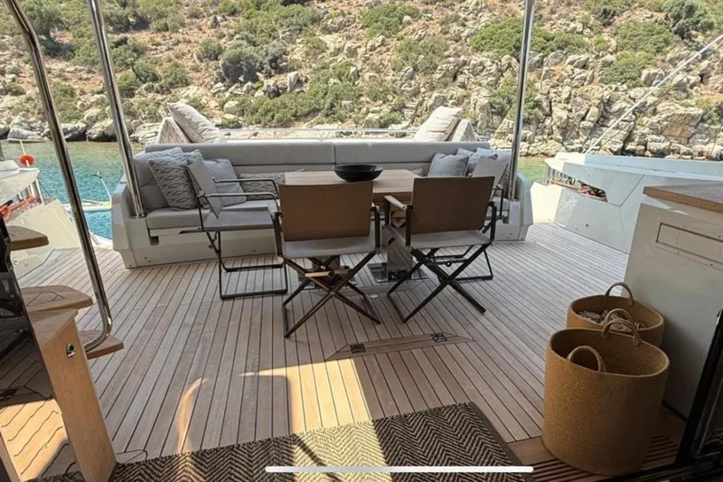  Yacht Photos Pics Outdoor seating area on 2022 Numarine 22XP yacht with scenic coastal view.