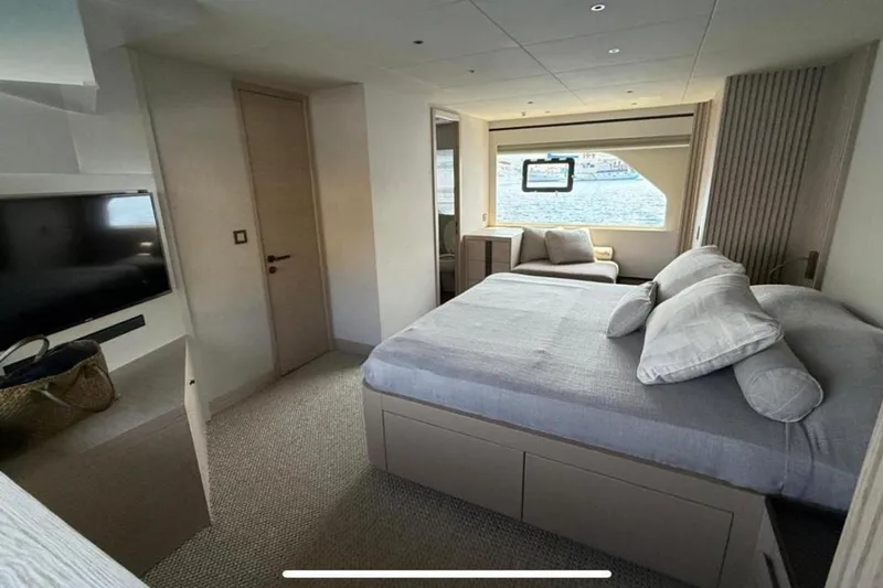  Yacht Photos Pics Luxurious bedroom interior of 2022 Numarine 22XP yacht with modern design and large window view.