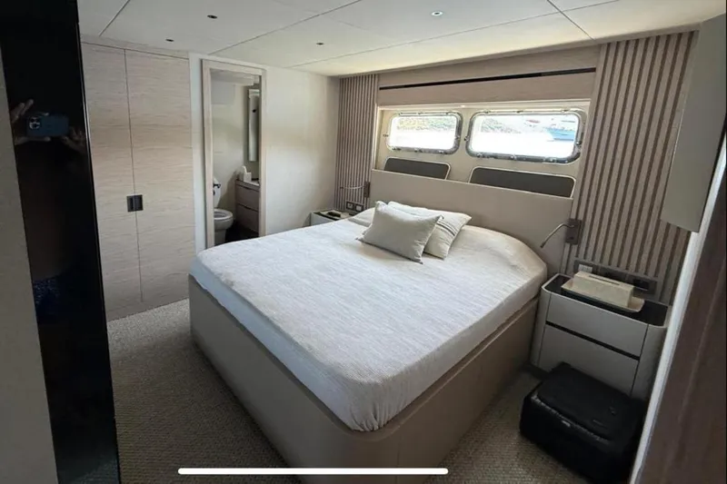  Yacht Photos Pics Luxurious bedroom interior of 2022 Numarine 22XP yacht with modern design and ensuite bathroom.