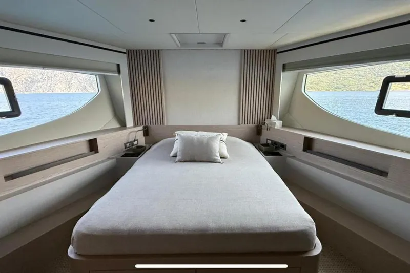  Yacht Photos Pics Luxurious bedroom interior of 2022 Numarine 22XP yacht with scenic ocean view.
