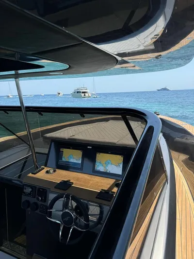 New 2025 Moon 45 Sports Line Yacht Photos Pics Modern Moon 45 Sportsline yacht cockpit with navigation screens, steering wheel, and ocean view, 2025 model.