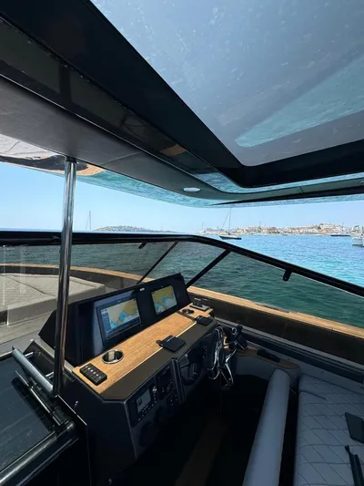 New 2025 Moon 45 Sports Line Yacht Photos Pics Interior view of 2025 Moon 45 Sportsline yacht cockpit with navigation screens and ocean backdrop.