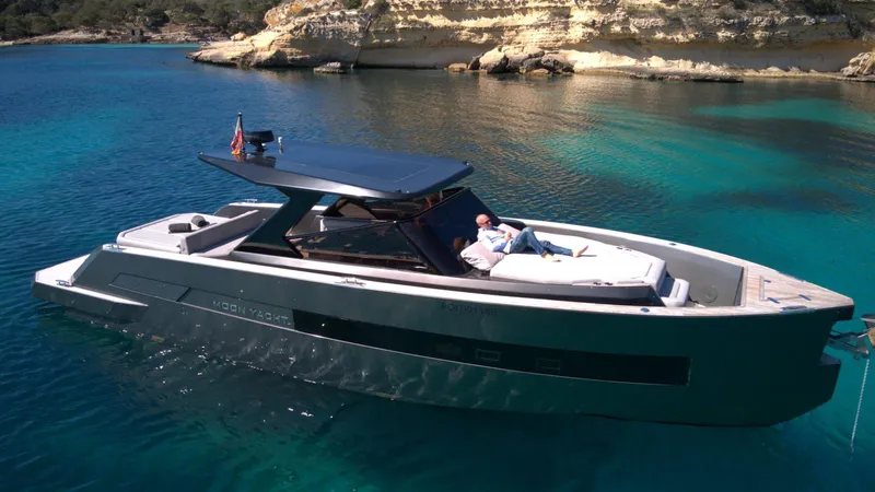 New 2025 Moon 45 Sports Line Yacht Photos Pics Luxury 2025 Moon 45 Sportsline yacht on clear blue water, featuring sleek design and sunbathing area.