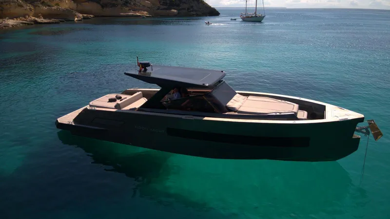 New 2025 Moon 45 Sports Line Yacht Photos Pics 2025 Moon 45 Sportsline yacht on clear turquoise water, anchored near rocky coastline.