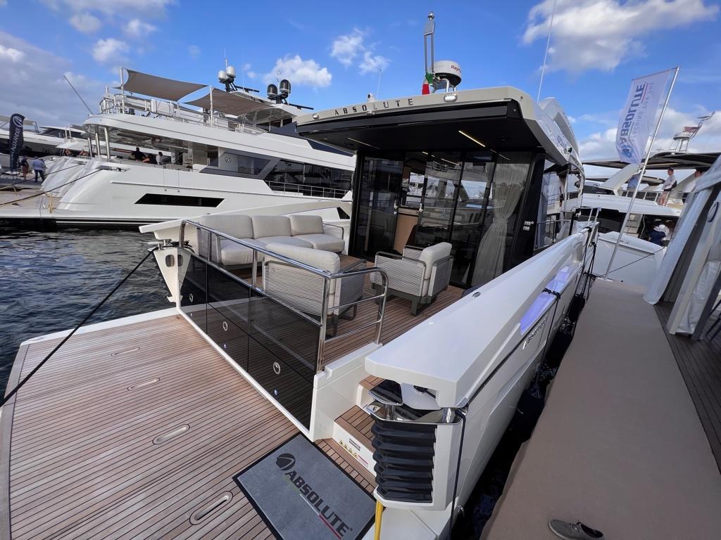 2025 Absolute 48 Coupe yacht docked, showcasing sleek design and luxurious outdoor seating.