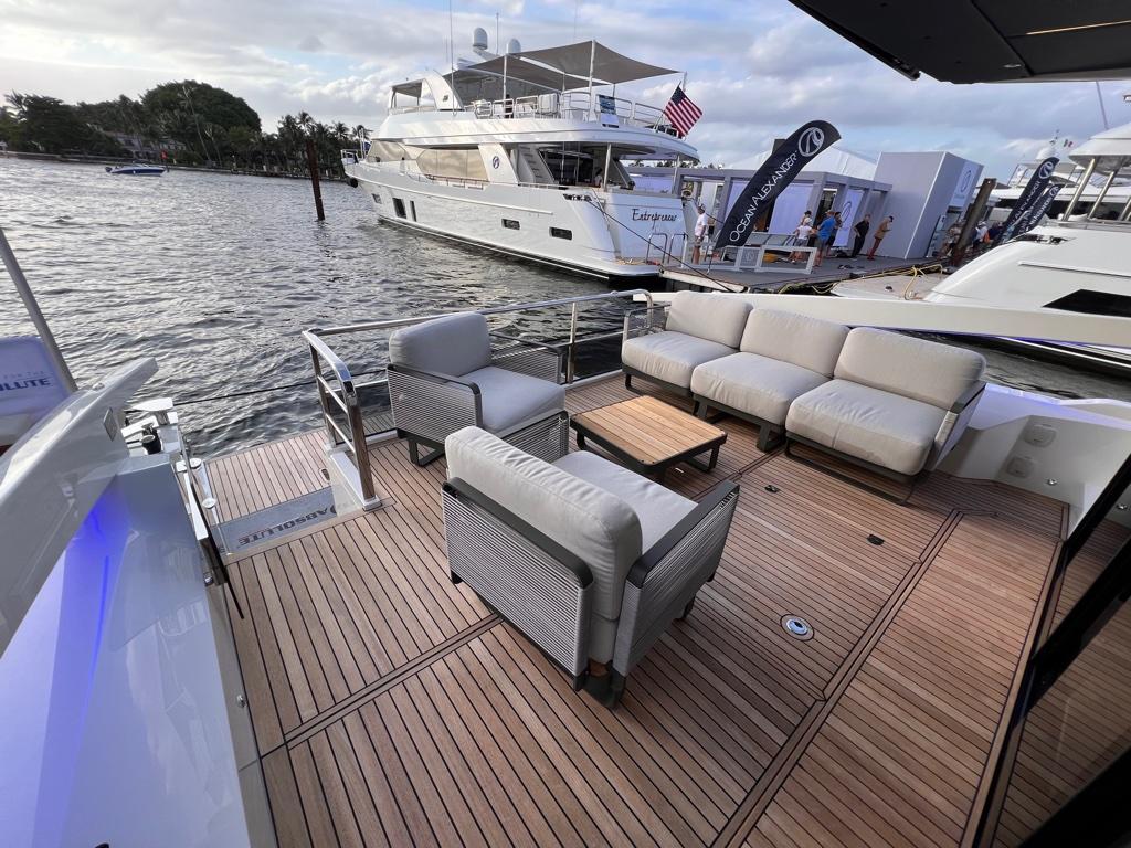 Luxurious 2025 Absolute 48 Coupe yacht with spacious deck and elegant seating on the water.